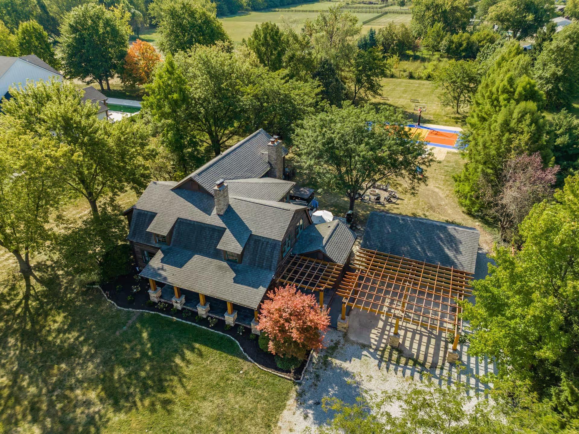 Backyard estate with playset, fire pit, and string lights